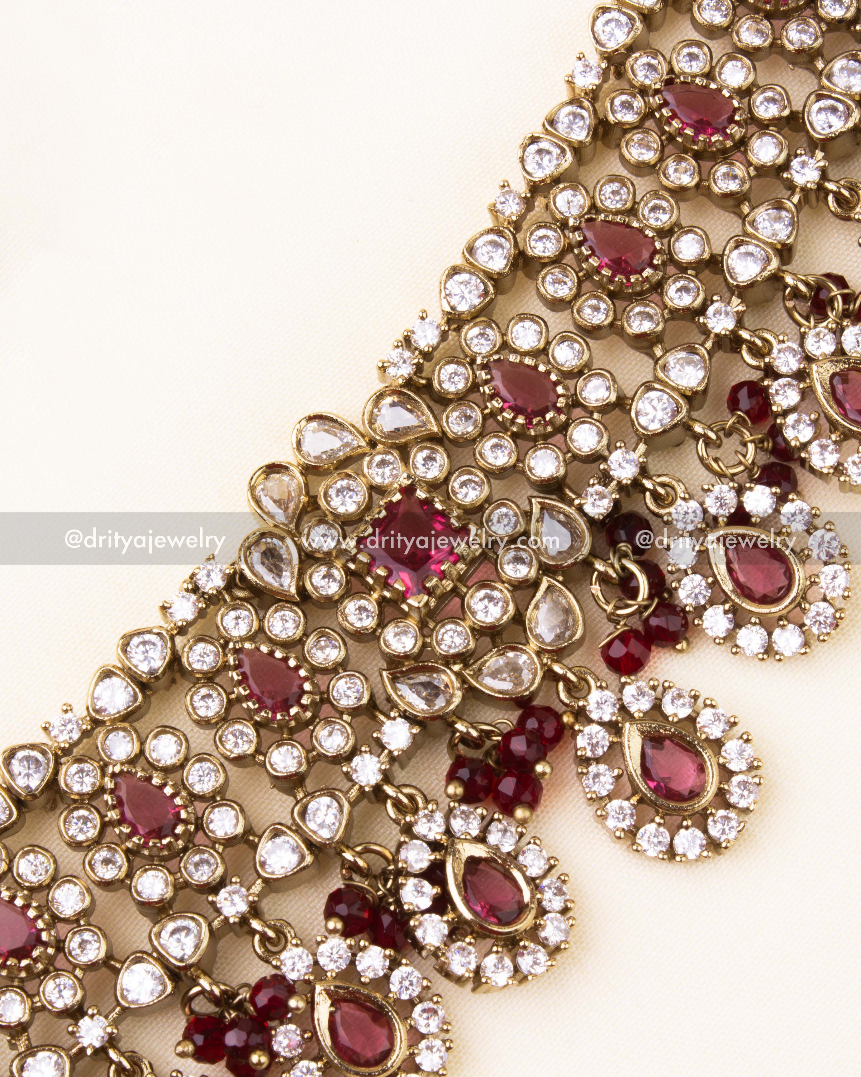 Detailed AD-studded choker necklace with red teardrop stones and bead dangles.