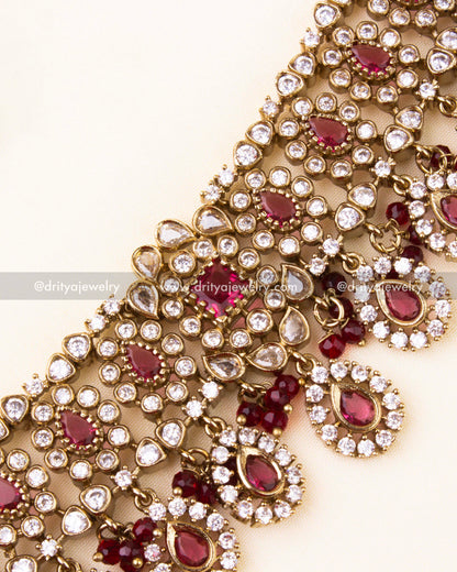 Detailed AD-studded choker necklace with red teardrop stones and bead dangles.
