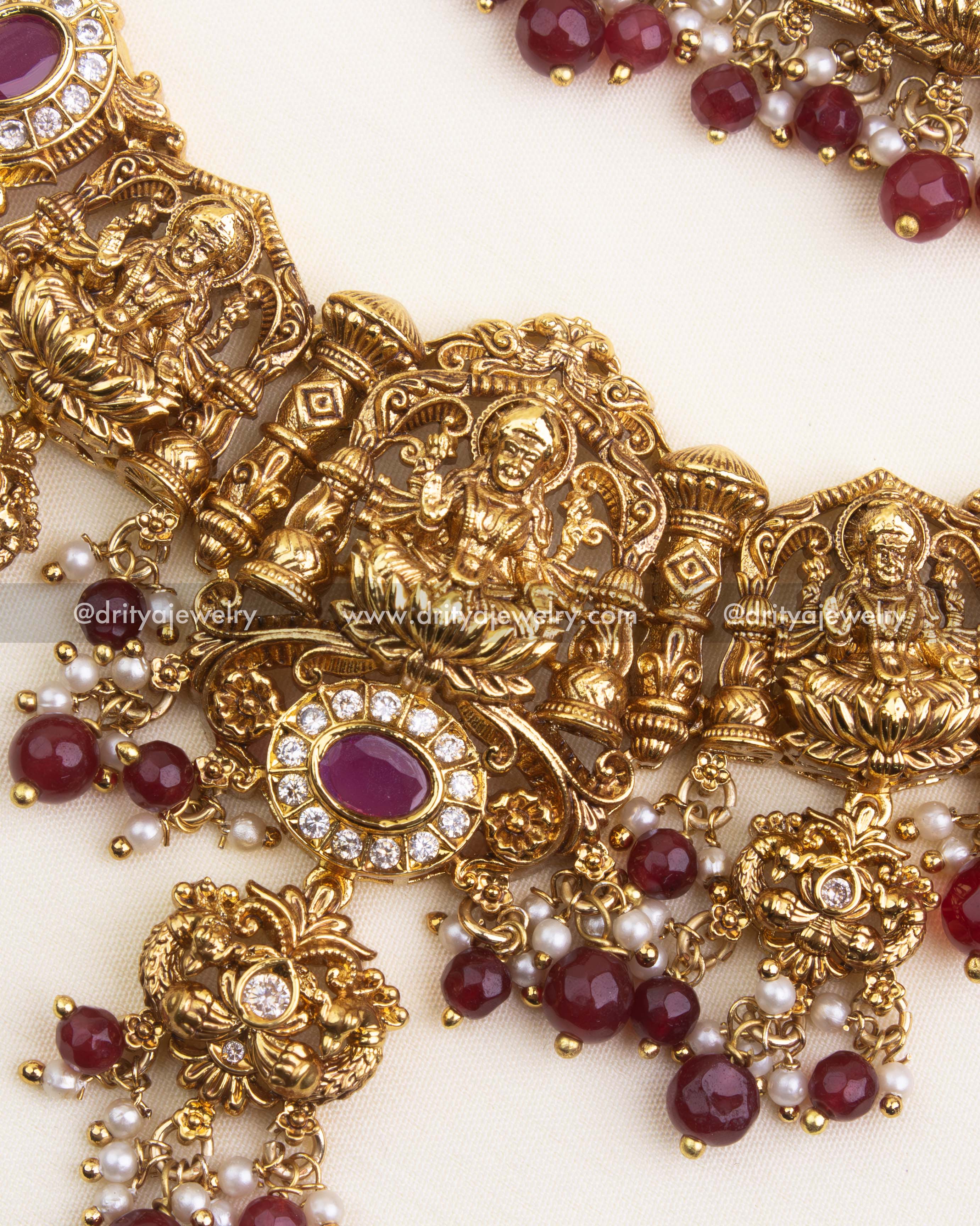 Lakshmi pendant with ruby accents, CZ stones, and ruby bead hangings.