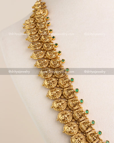 Detailed side view of haram necklace showing green stone insets and mythical yali design.