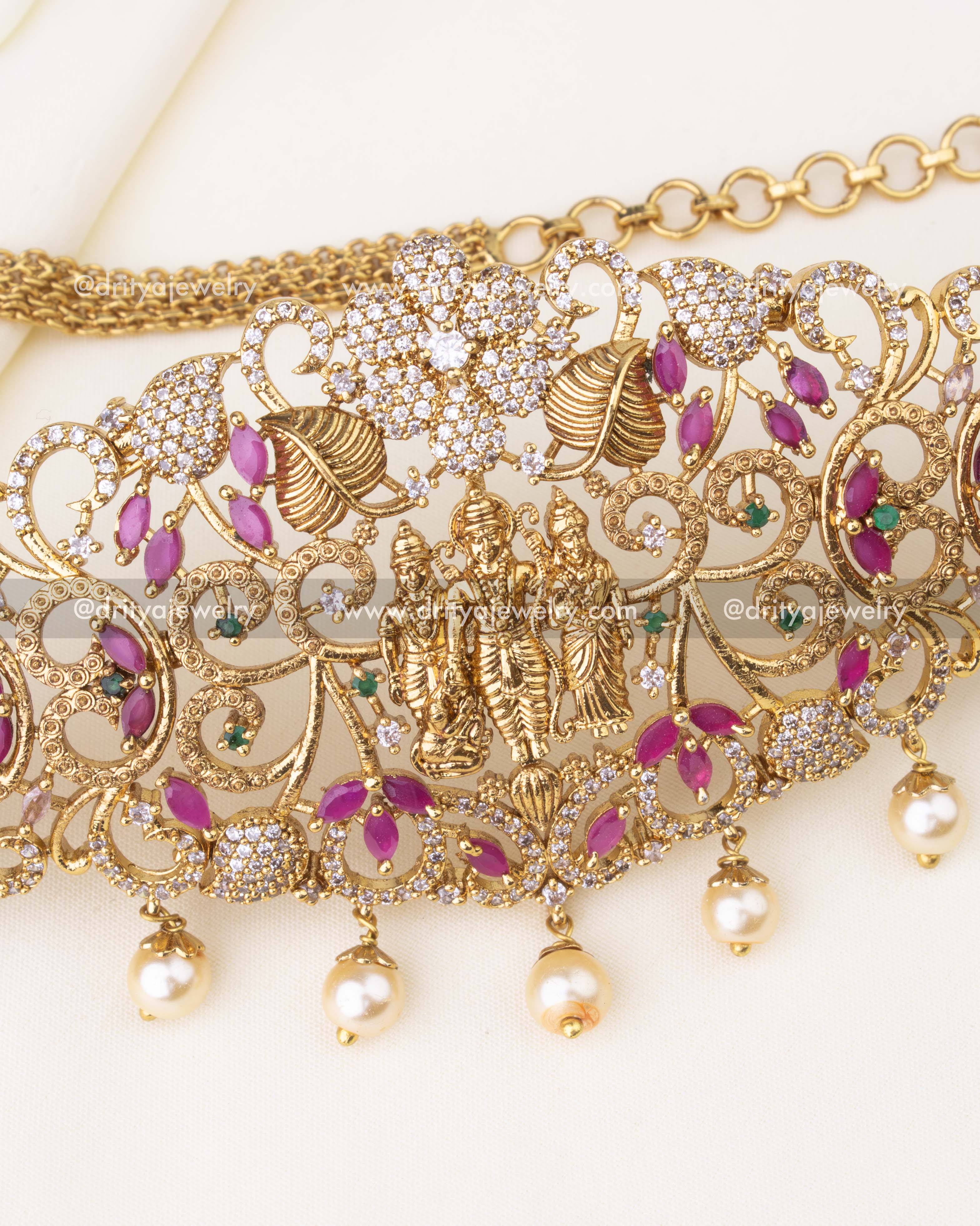 Detailed view of Lakshmi centerpiece, CZ stones, and intricate floral motifs in hip chain.