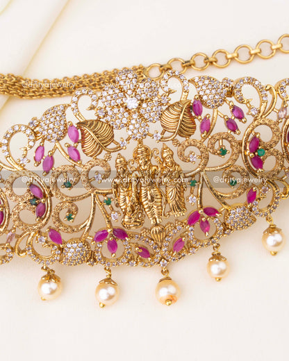 Detailed view of Lakshmi centerpiece, CZ stones, and intricate floral motifs in hip chain.