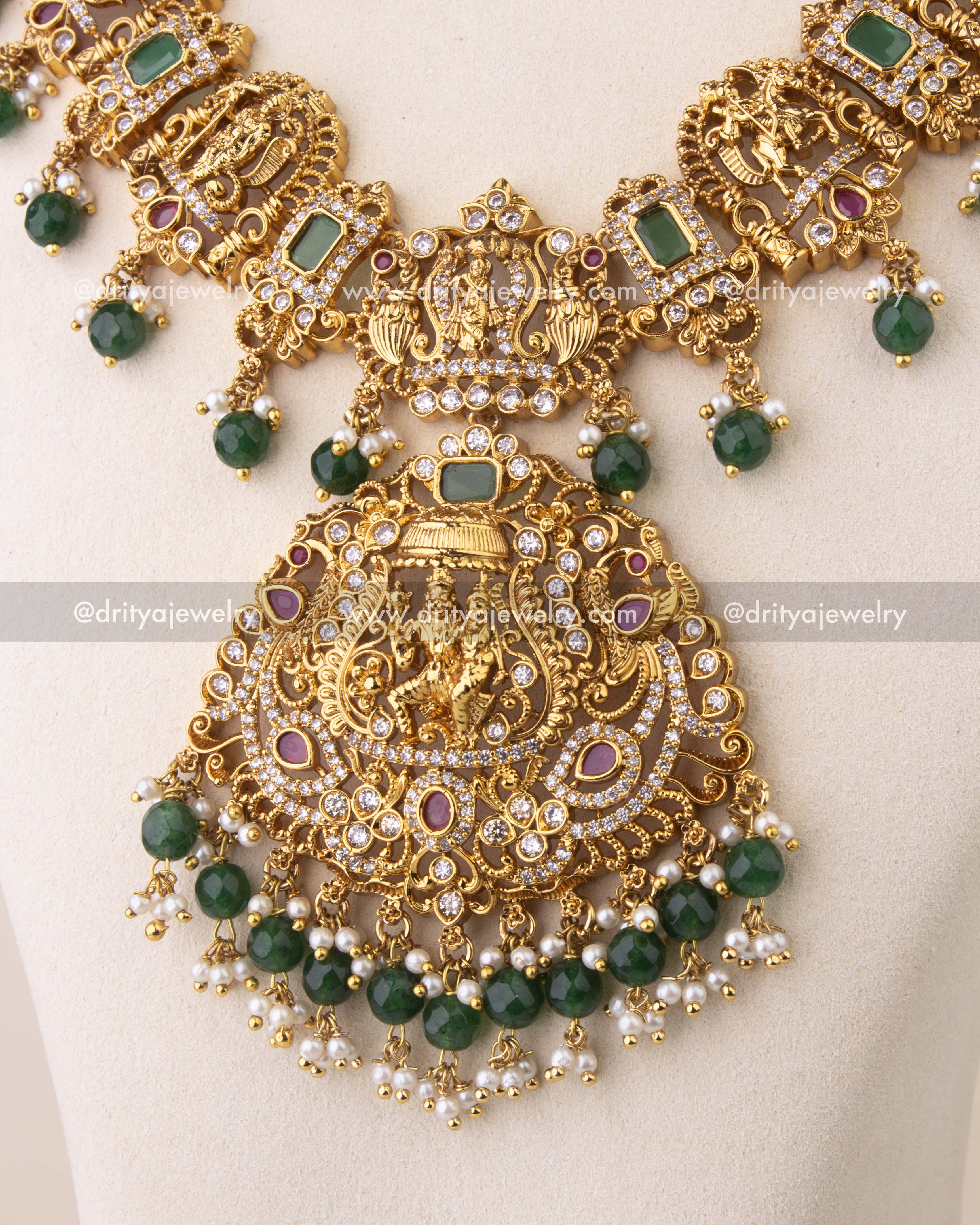 Detailed close-up of Lord Narasimha pendant adorned with CZ stones, ruby details, and pearl-green bead hangings.