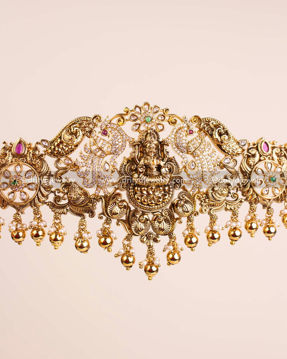 Close-up view highlighting the central goddess motif, peacocks, floral vines, and polki stones on the Nakshi waist belt.