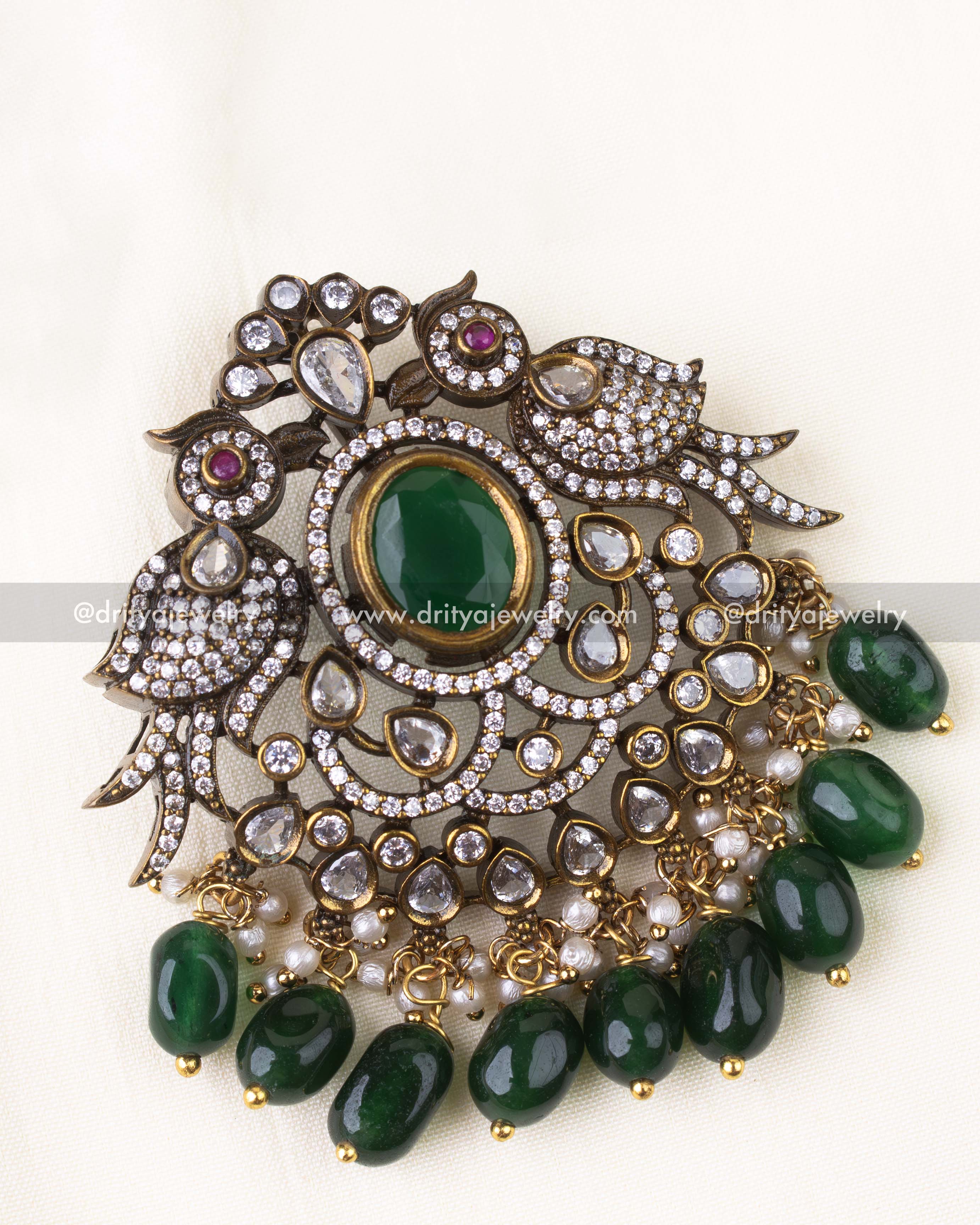 Detailed close-up of twin peacock pendant design with AD stones and green beads.