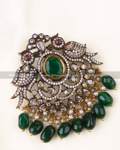 Detailed close-up of twin peacock pendant design with AD stones and green beads.