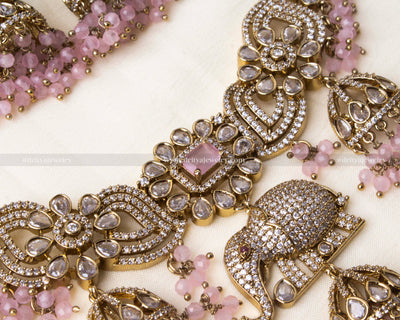 Close-up of Elephant Centerpiece" Alt Text: "Detailed view of the Victorian necklace's elephant centerpiece with sparkling AD stones and pink bead drops.