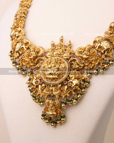 Close-up of Lakshmi pendant with intricate nakshi work and green bead drops