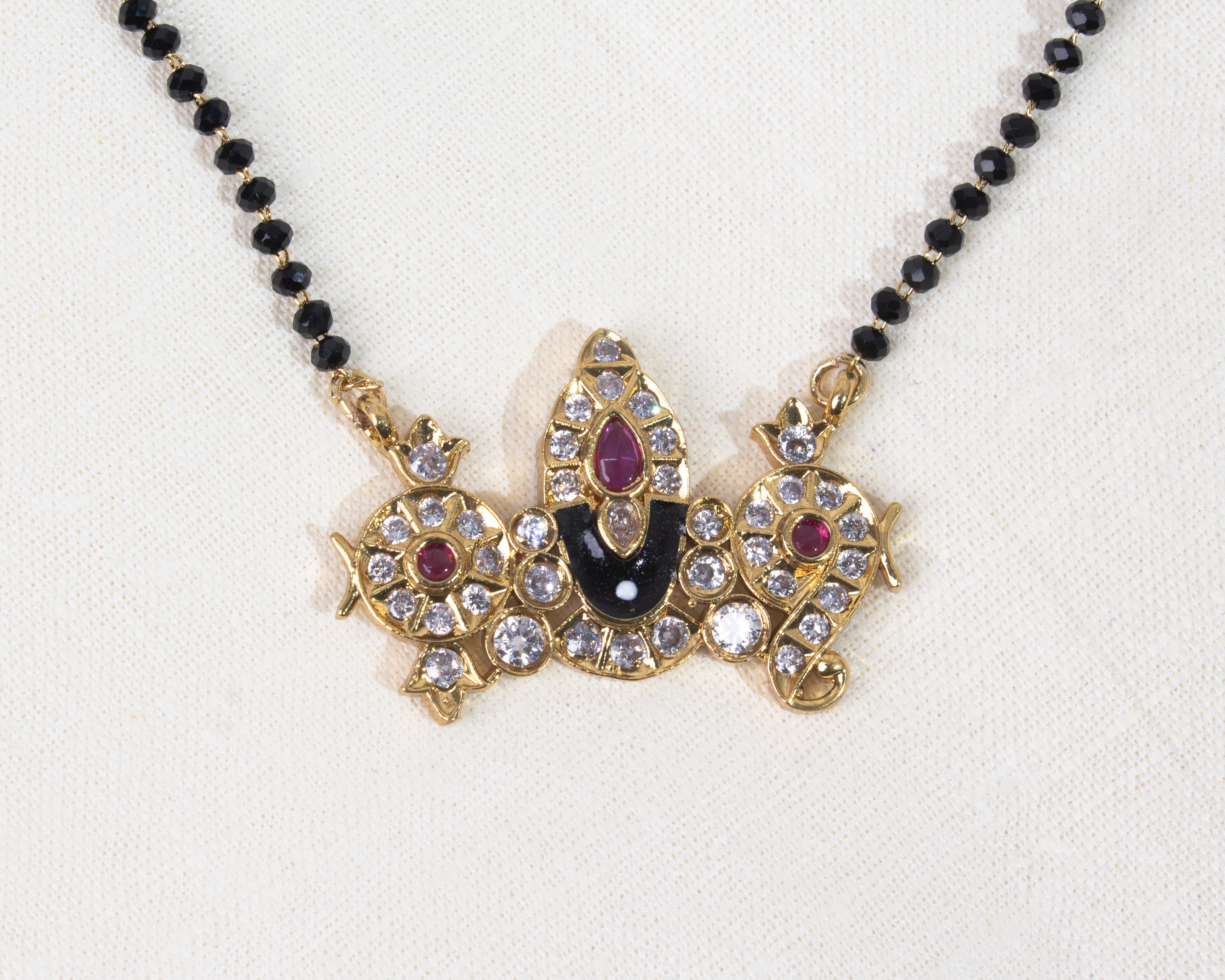 Close-up view showing the detailed craftsmanship of the Lord Balaji pendant on a black bead necklace by Dritya Jewelry.