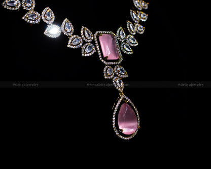 Close-up view of the Victorian Finish Necklace by Dritya Jewelry featuring a pink gemstone and CZ stone embellishments.