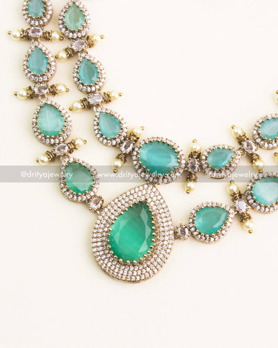 Detailed close-up of the mint green tear-drop pendant with double-layer CZ diamond setting.