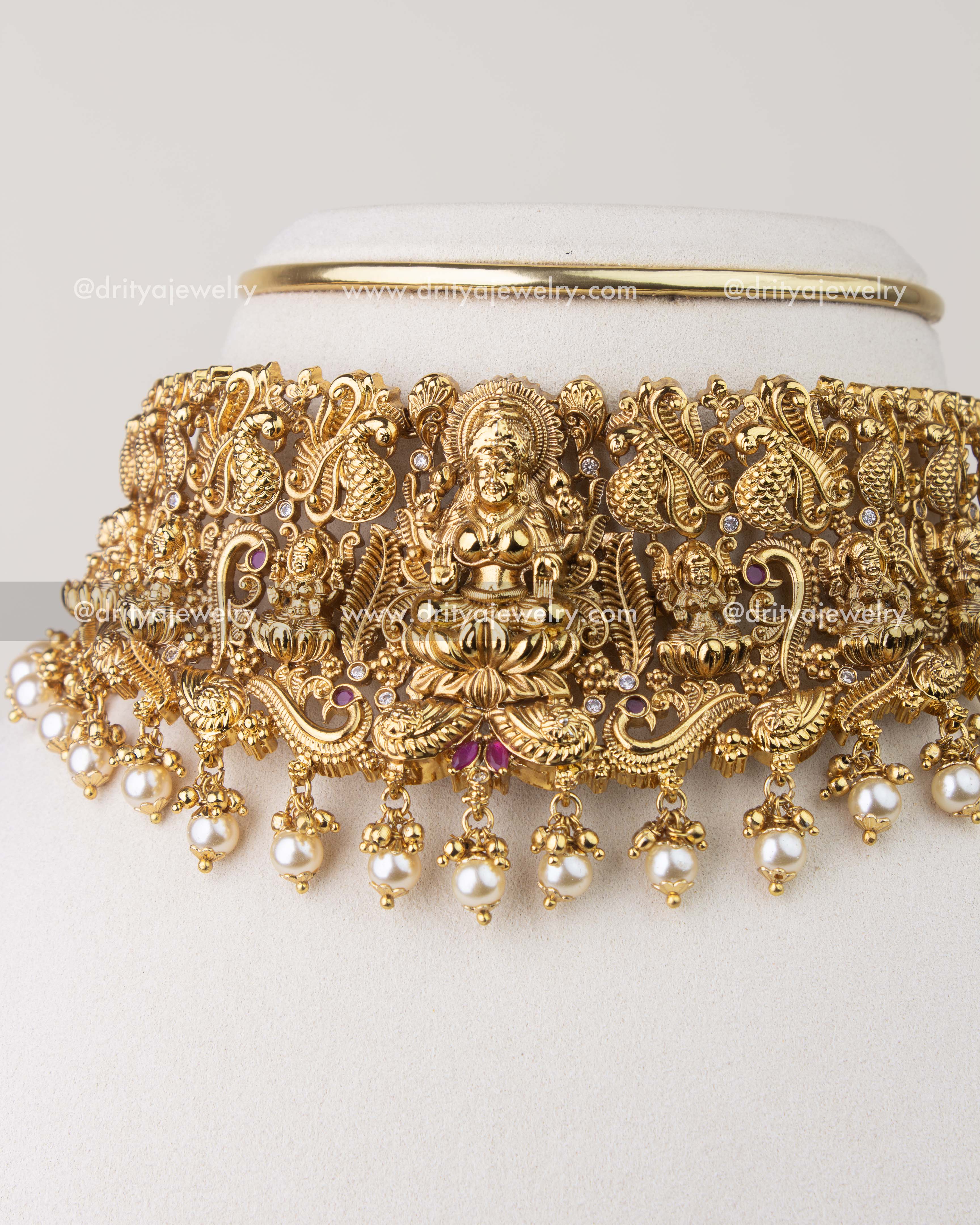 Close-up of Nakshi temple choker showing peacock motifs and pearl hangings