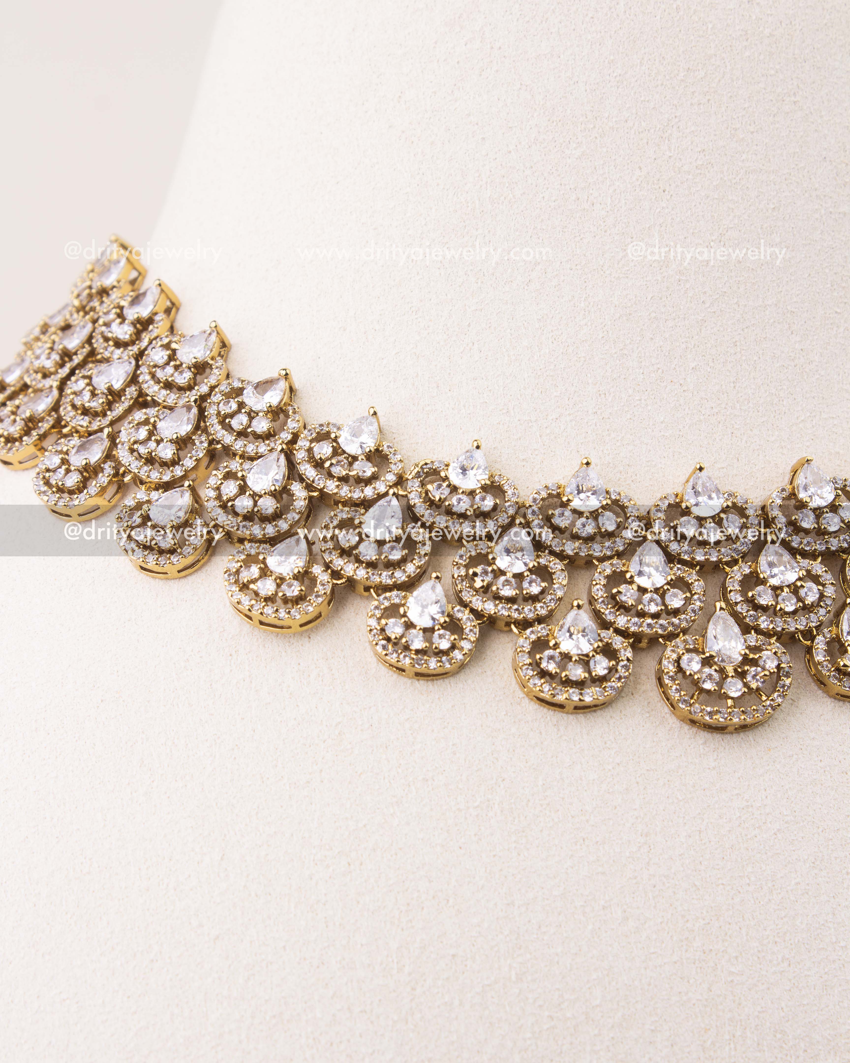 Close-up of Victorian necklace with teardrop diamond-alike stones and circular CZ motifs