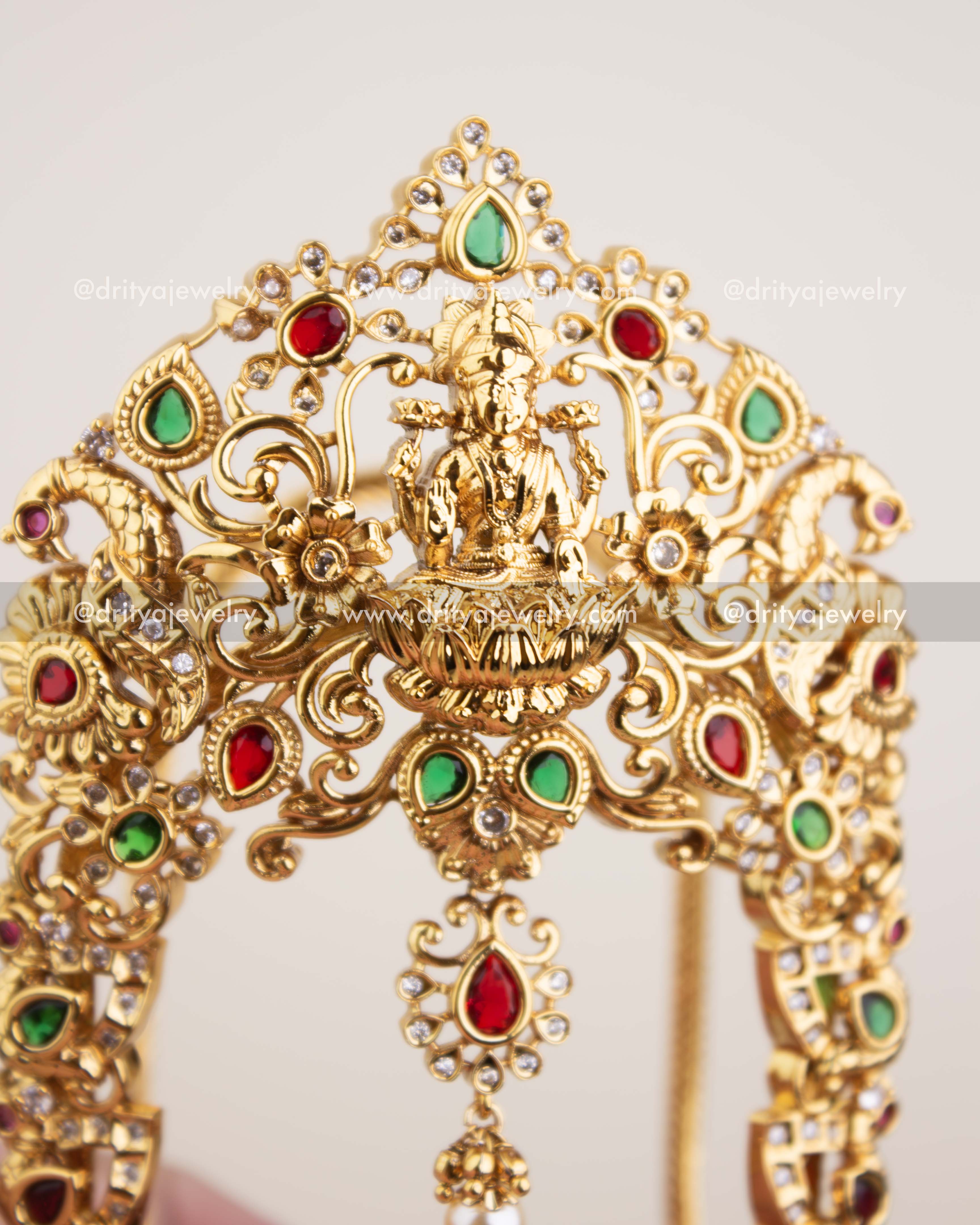 Close-up of Goddess Lakshmi centerpiece with CZ stones and multicolour gem accents.
