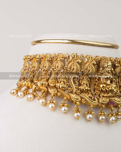 Close-up of Nakshi temple choker showing peacock motifs and pearl hangings