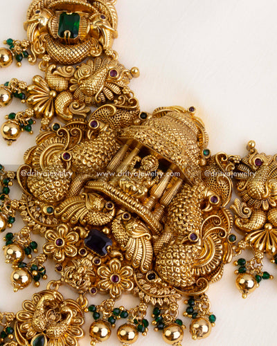 Close-up of central temple pendant with intricate peacocks, Lakshmi Devi, floral details, and multicolor beads