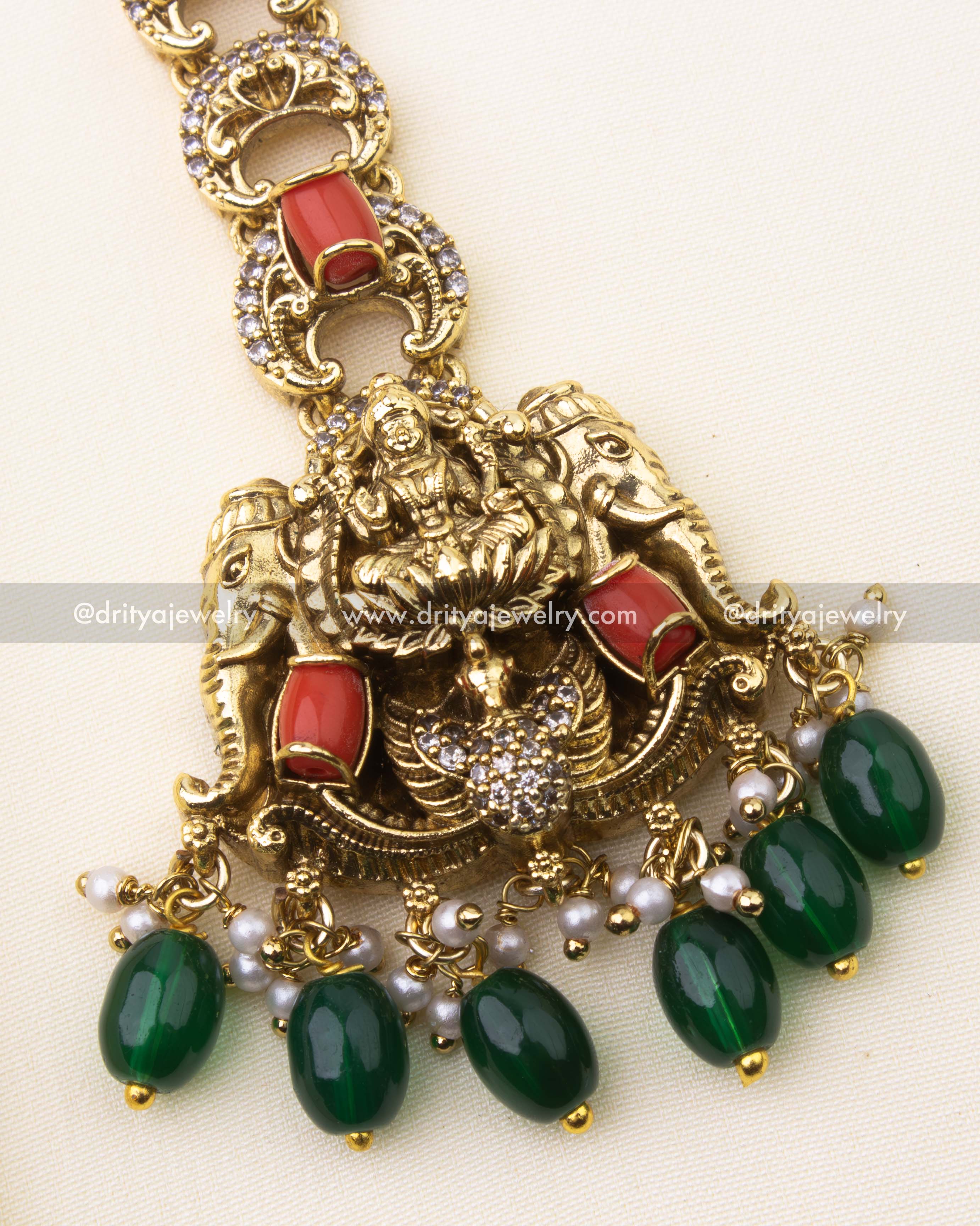 Detailed Lakshmi Devi motif with coral and green bead drops