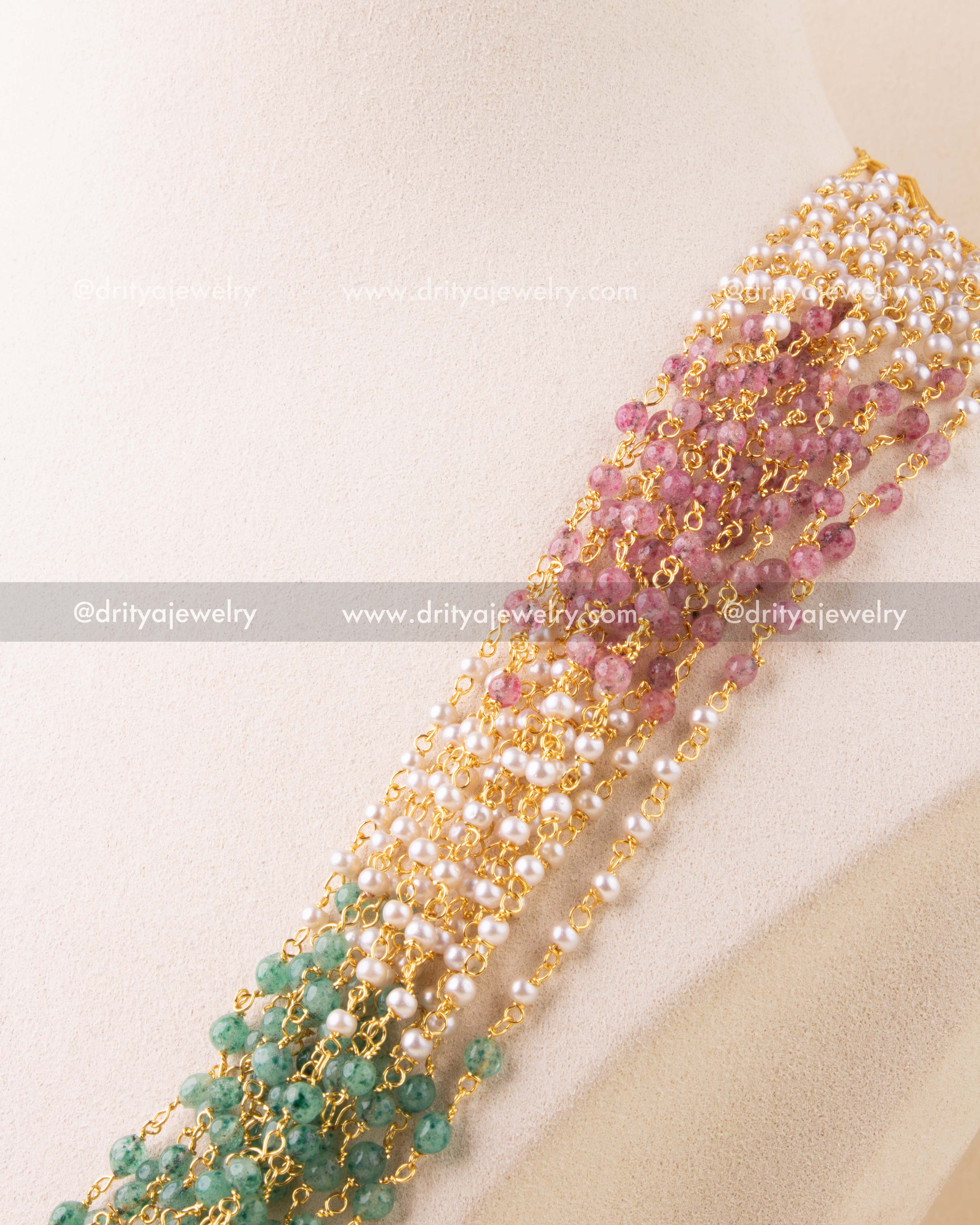 Detailed view of pearl and gemstone-style bead weaving in multi-strand necklace