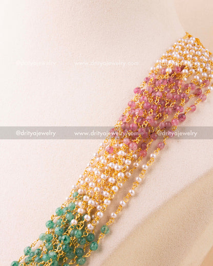 Detailed view of pearl and gemstone-style bead weaving in multi-strand necklace