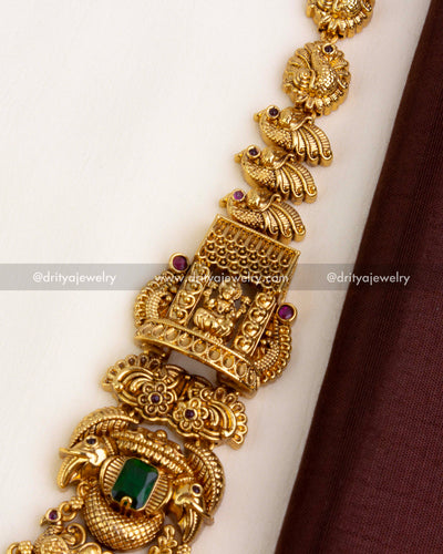 Zoomed-in view of side chain showing deity, bird motifs, and ruby-toned stones