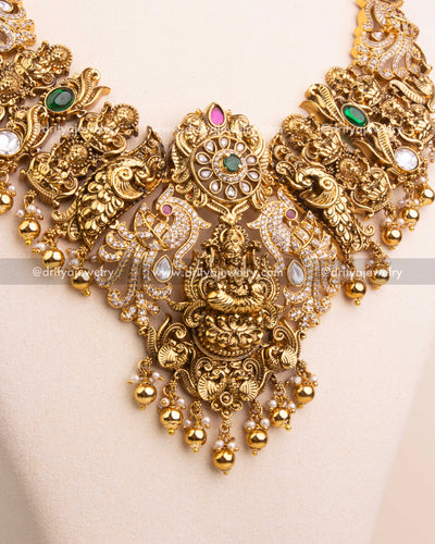 Central pendant of long necklace with Lakshmi motif and Kundan embellishments