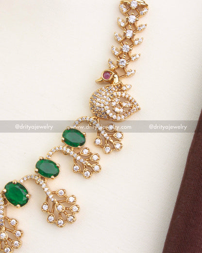 Close view of peacock detailing and sparkling CZ stones in emerald variant necklace set.