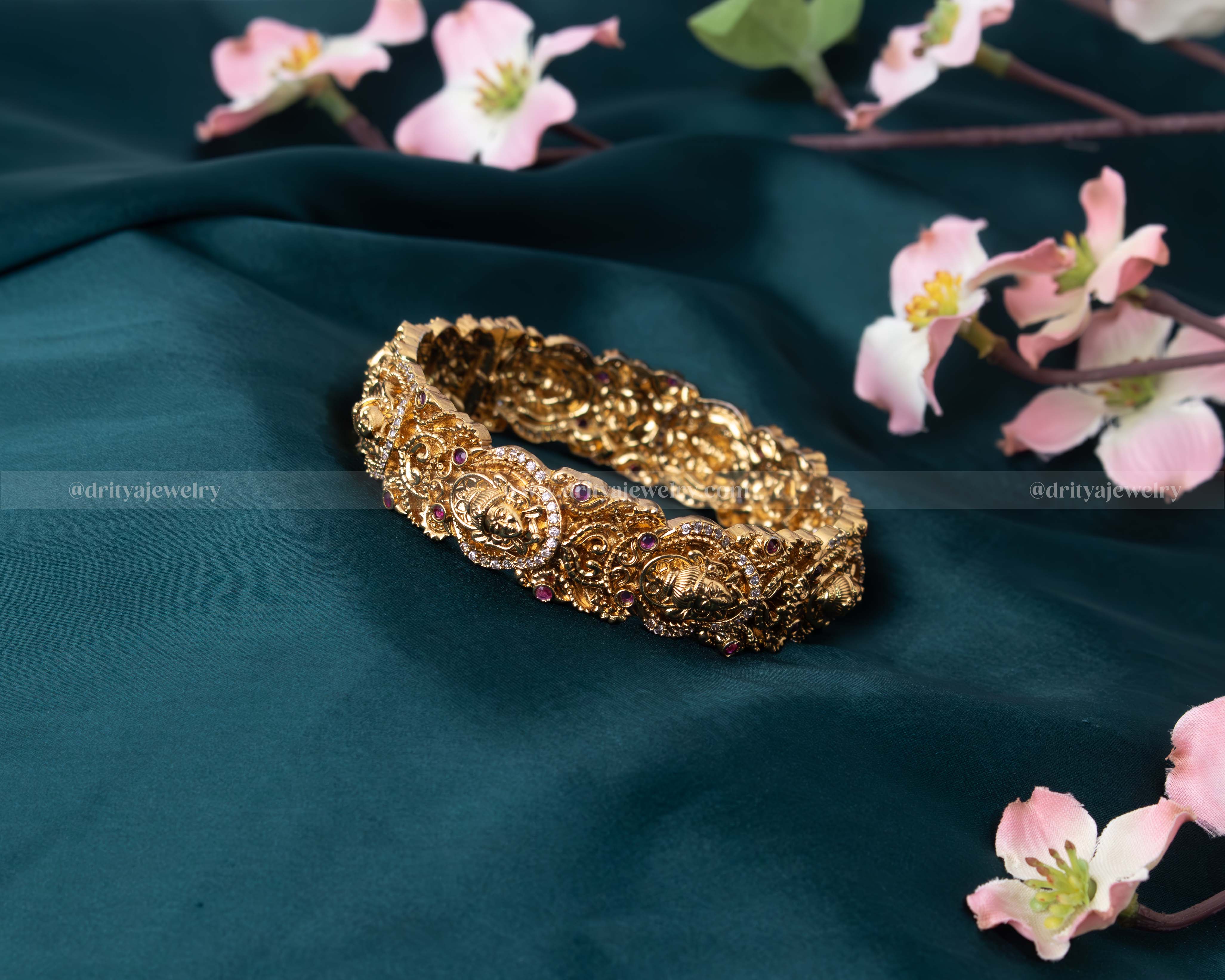 Detailed close-up of the Openable Temple Bangle highlighting its colorful gemstones and gold finish.