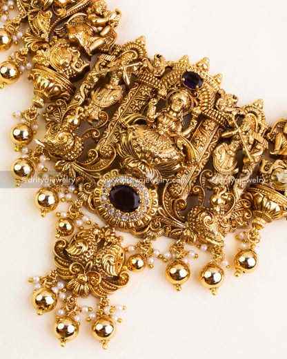 Close-up of Lakshmi Devi pendant showcasing intricate Nakshi carving with purple stone centerpiece and shimmering white CZ stones