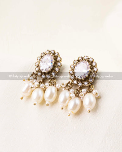 White earrings with pearl danglers and AD setting