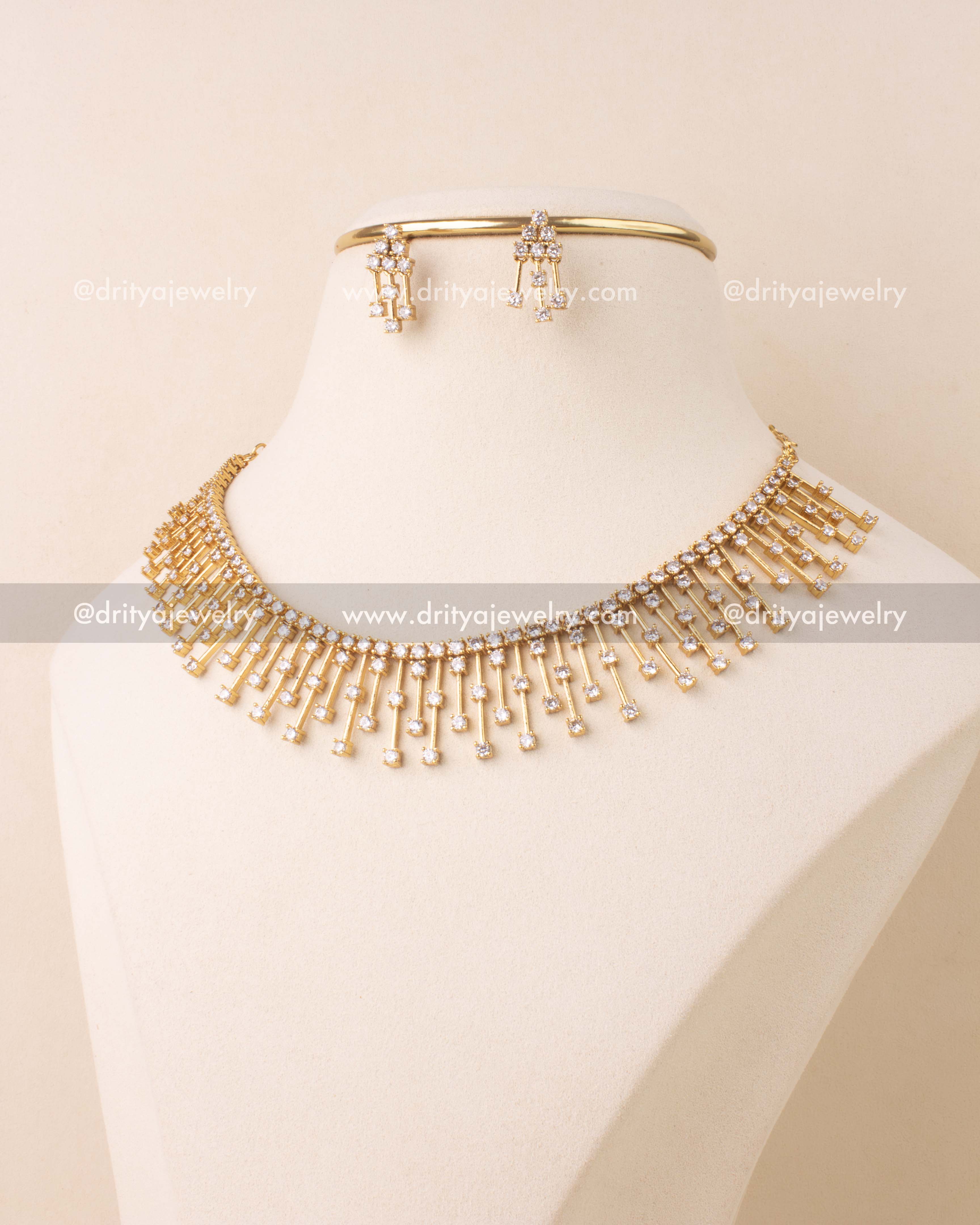 Short necklace set with white CZ stones on a gold-plated base, paired with matching earrings.
