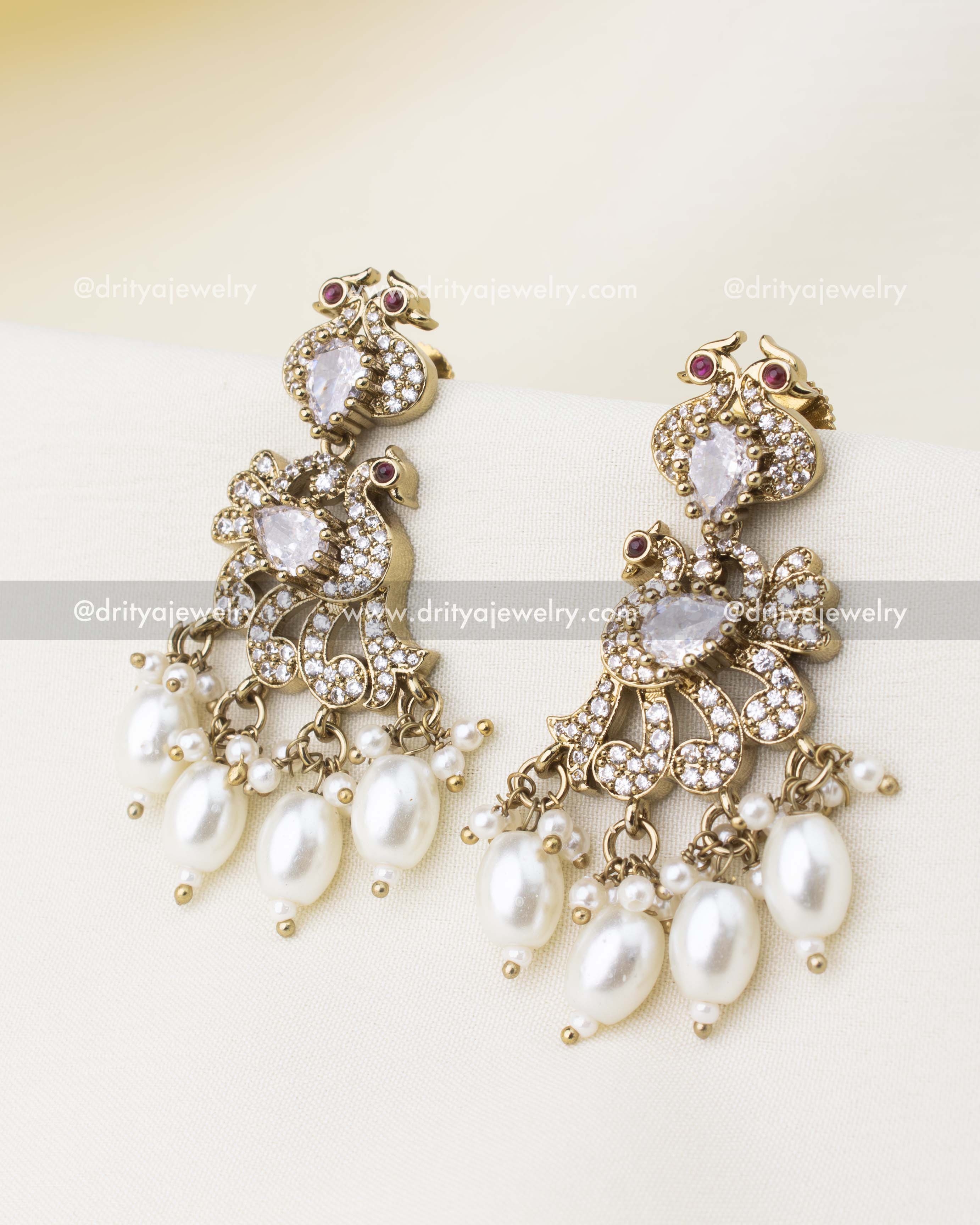 Victorian-inspired earrings with diamond white stones, CZ accents, and pearl hangings.
