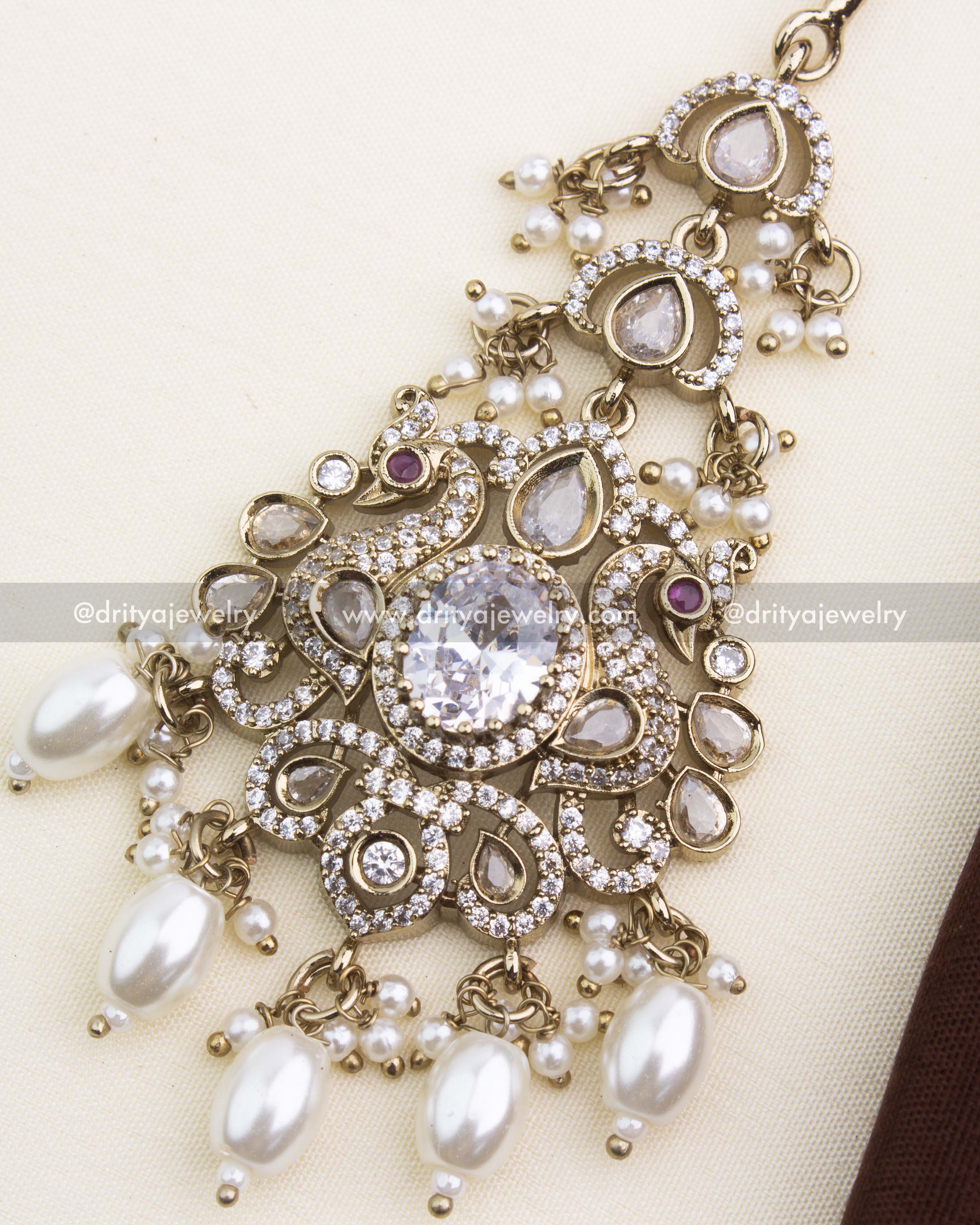 Close-up of clear white stone center, AD stones, and pearl hangings in Victorian finish