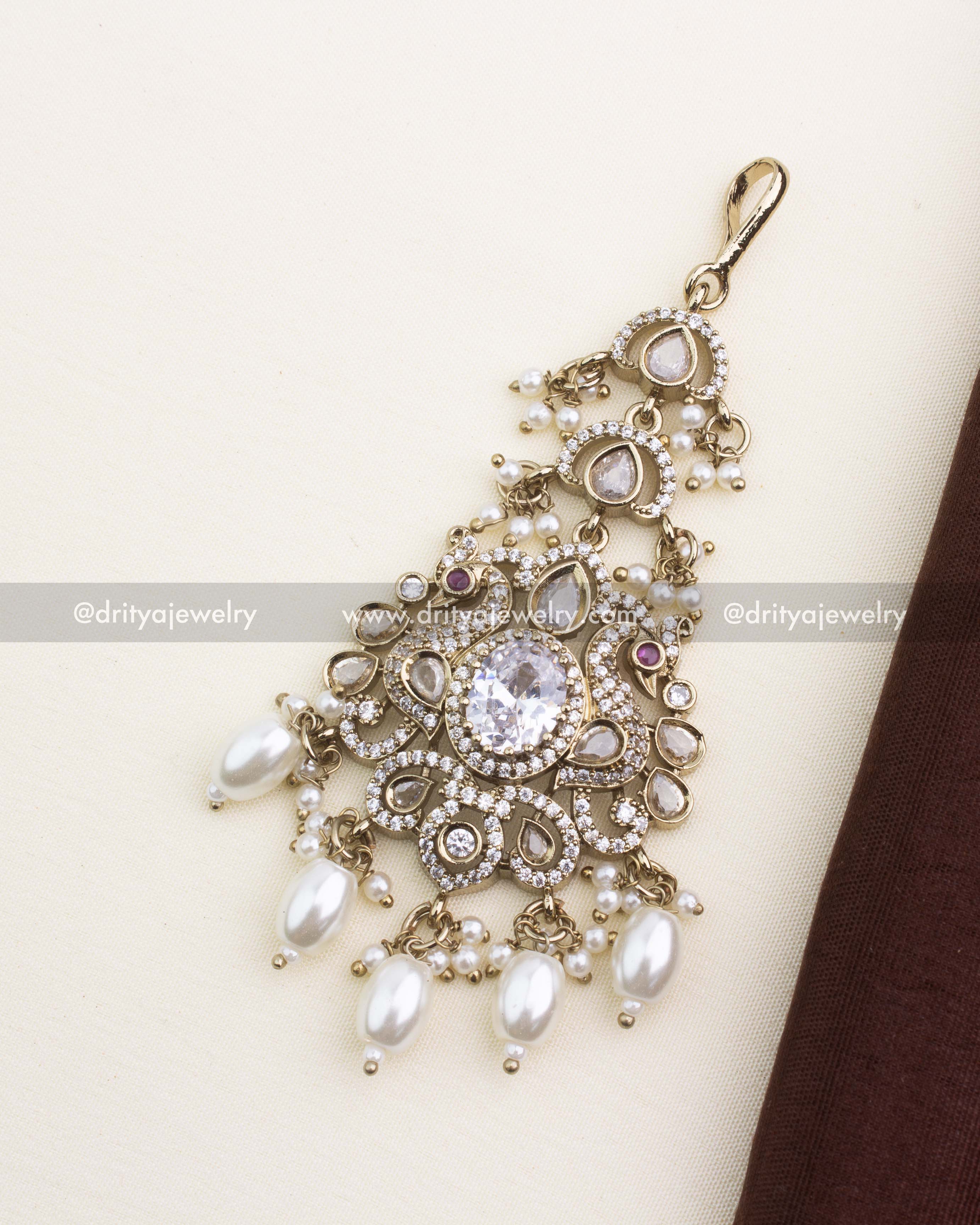 Victorian-style white stone bridal maang tikka with pearl-like drops and kundan accents