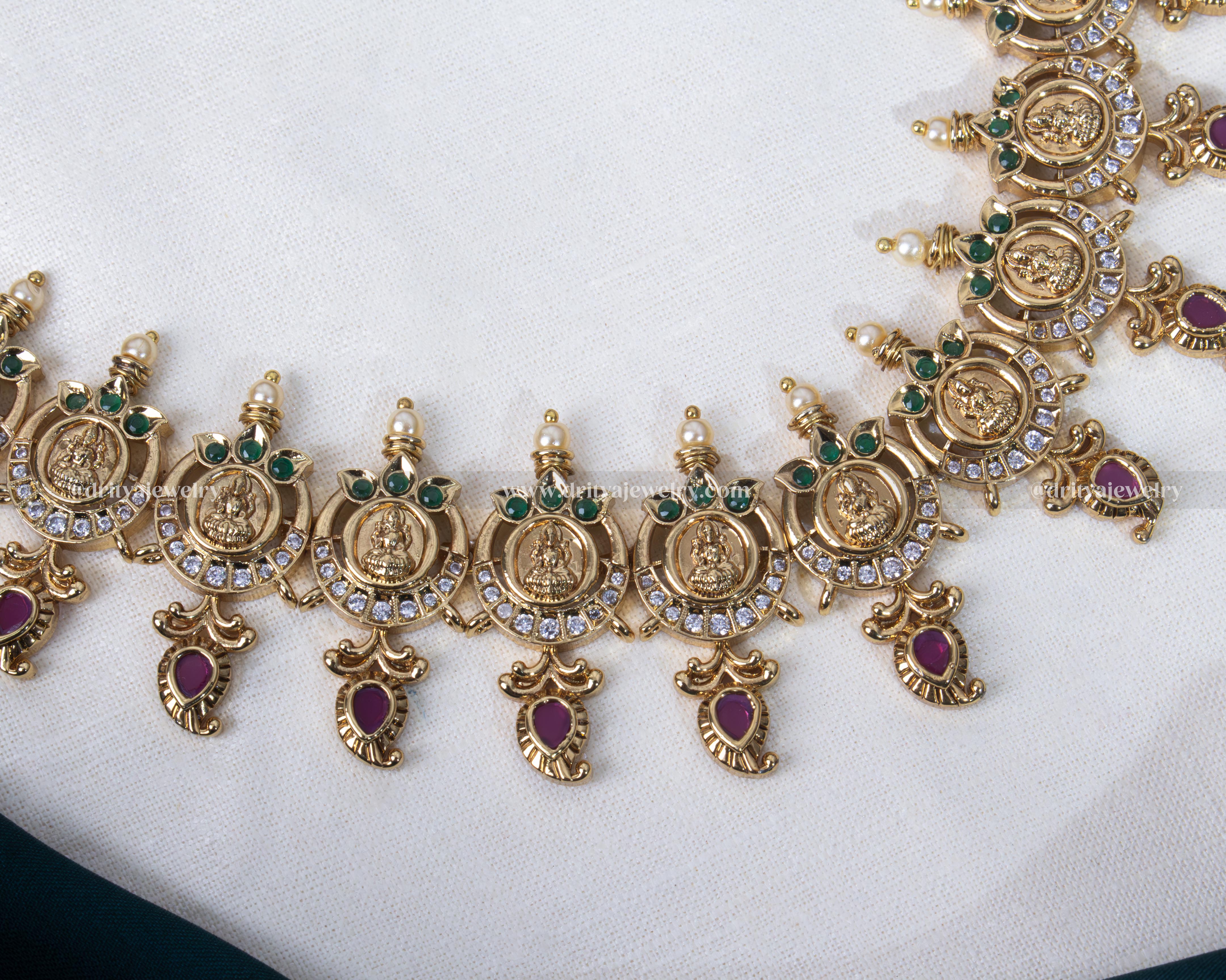 Elegant long necklace set featuring Lakshmi Devi coin motifs and polki stones with gold plating, ideal for weddings and festivities.