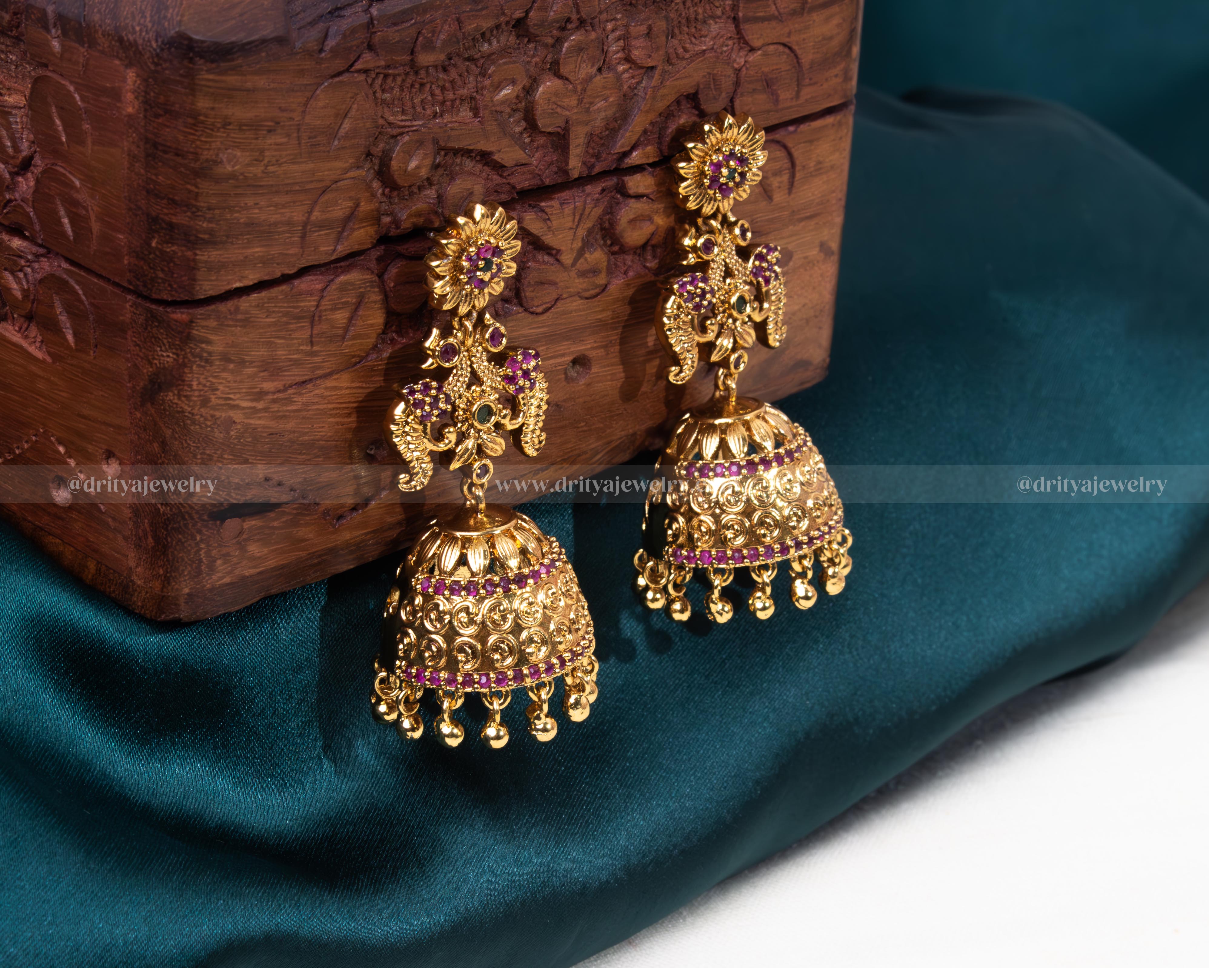 Front view of Dritya Jewelry's Royal Mughal Jhumka Earrings embellished with purple gemstones and intricate golden filigree.