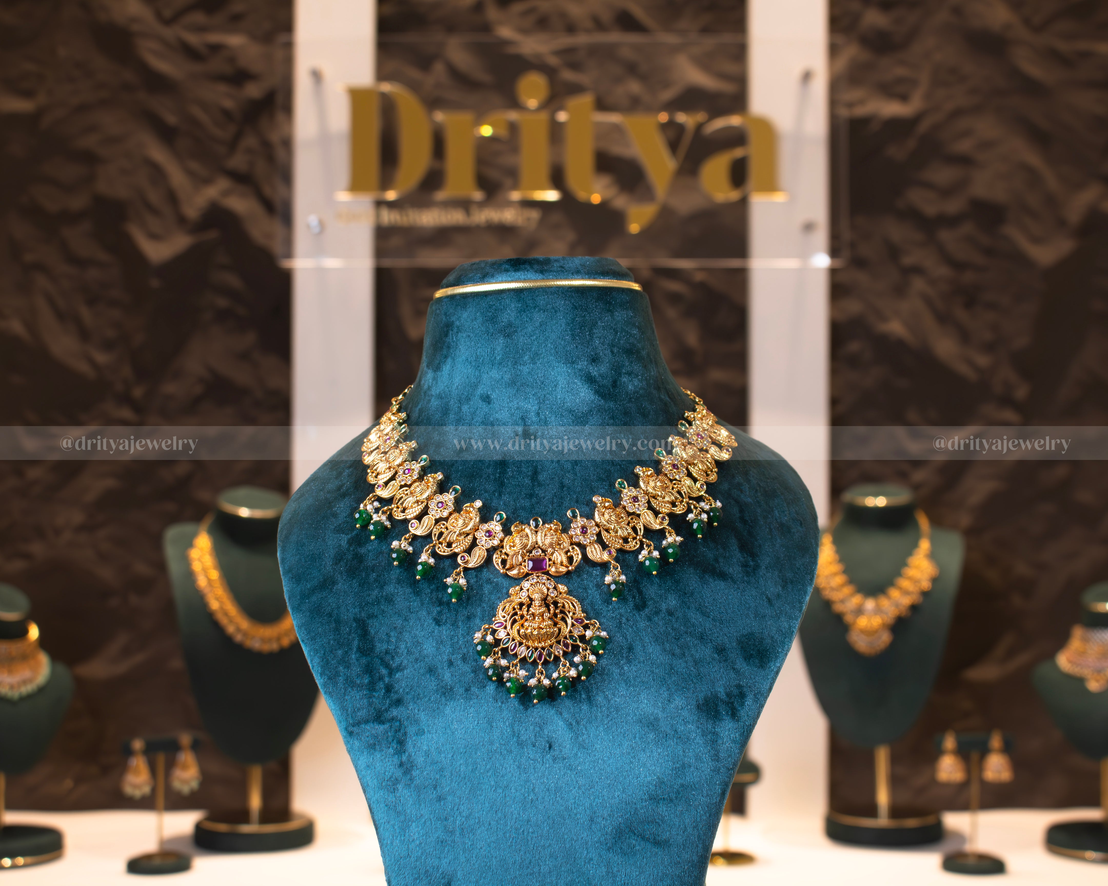 Front view of Dritya Jewelry's Temple Necklace Set with green beads, featuring Lakshmi pendant and peacock motifs.