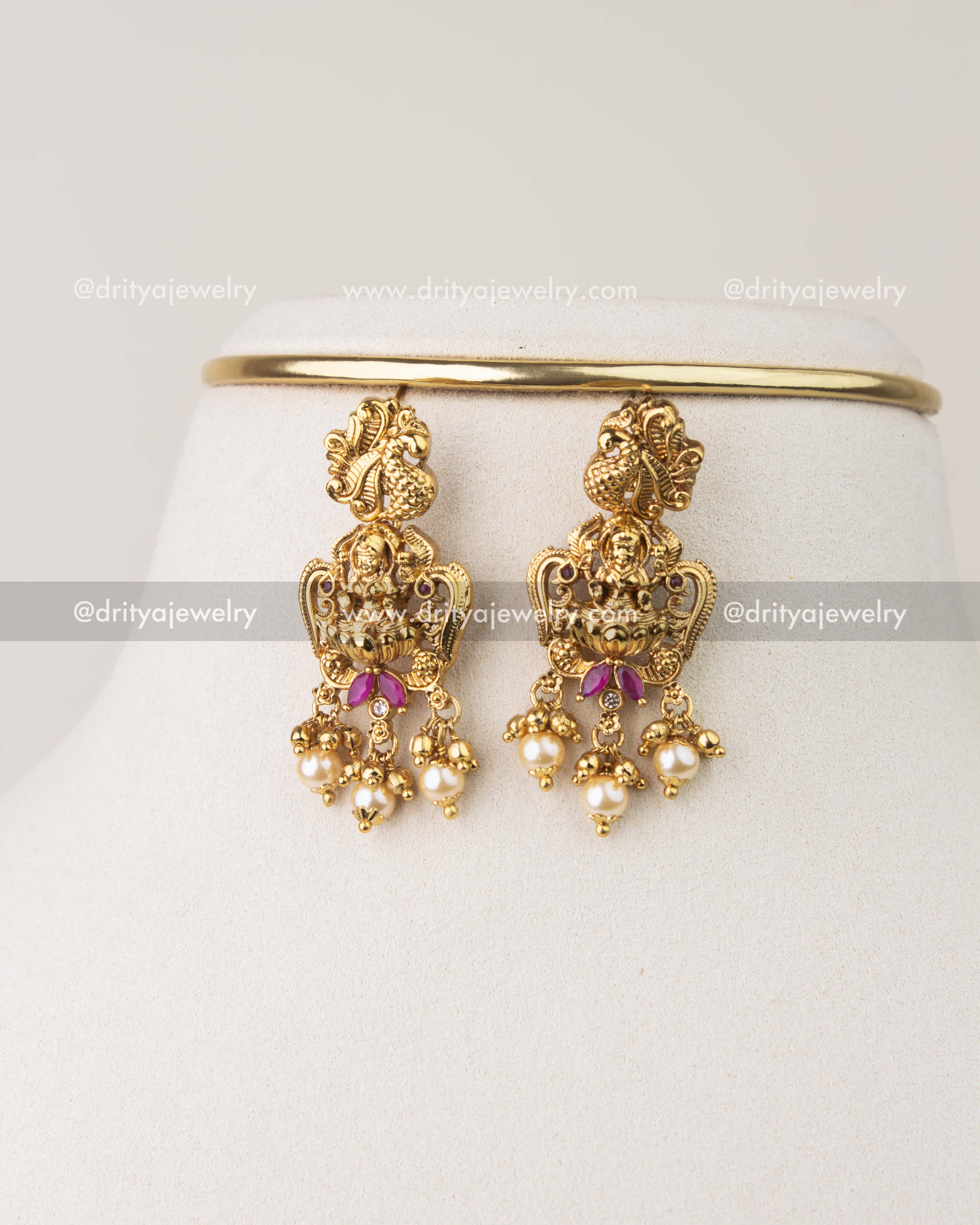 Nakshi temple earrings with Goddess motif, pearl drops, and antique gold polish