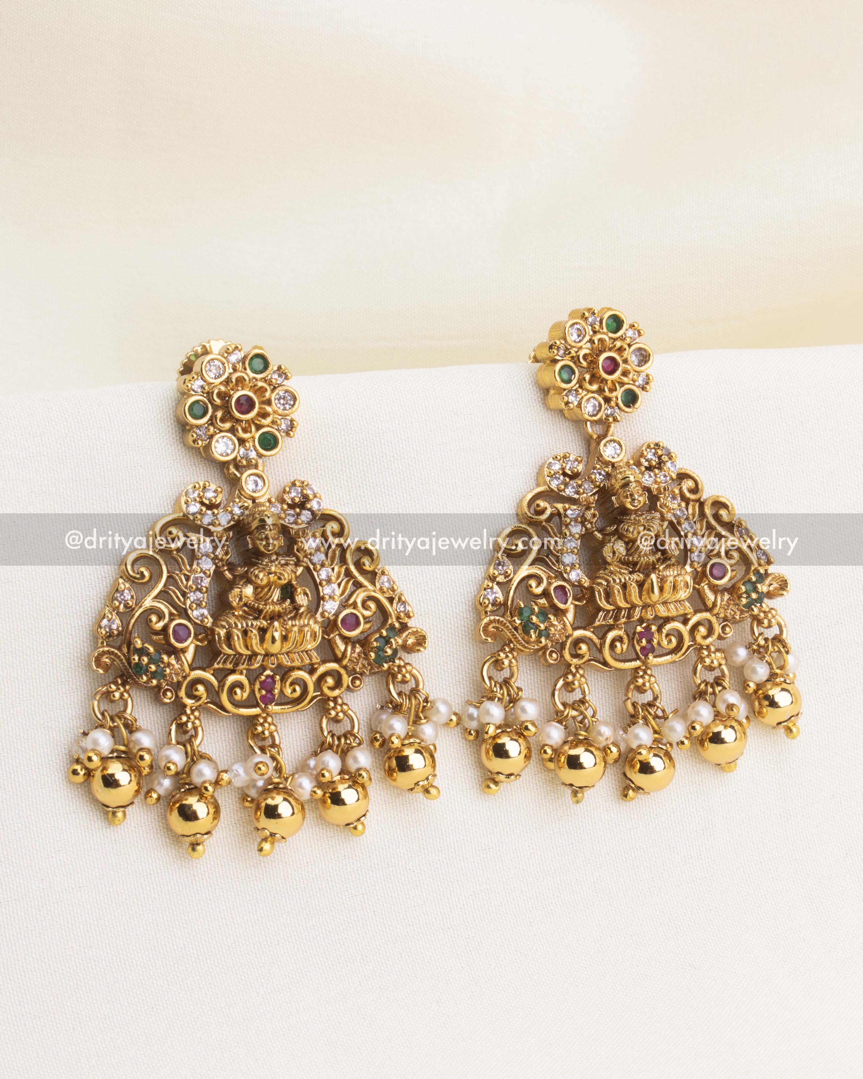 Temple-style jhumkas with goddess motif and pearl hangings