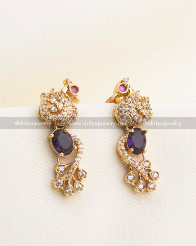 Purple earrings with peacock motif and sparkling CZ highlights.