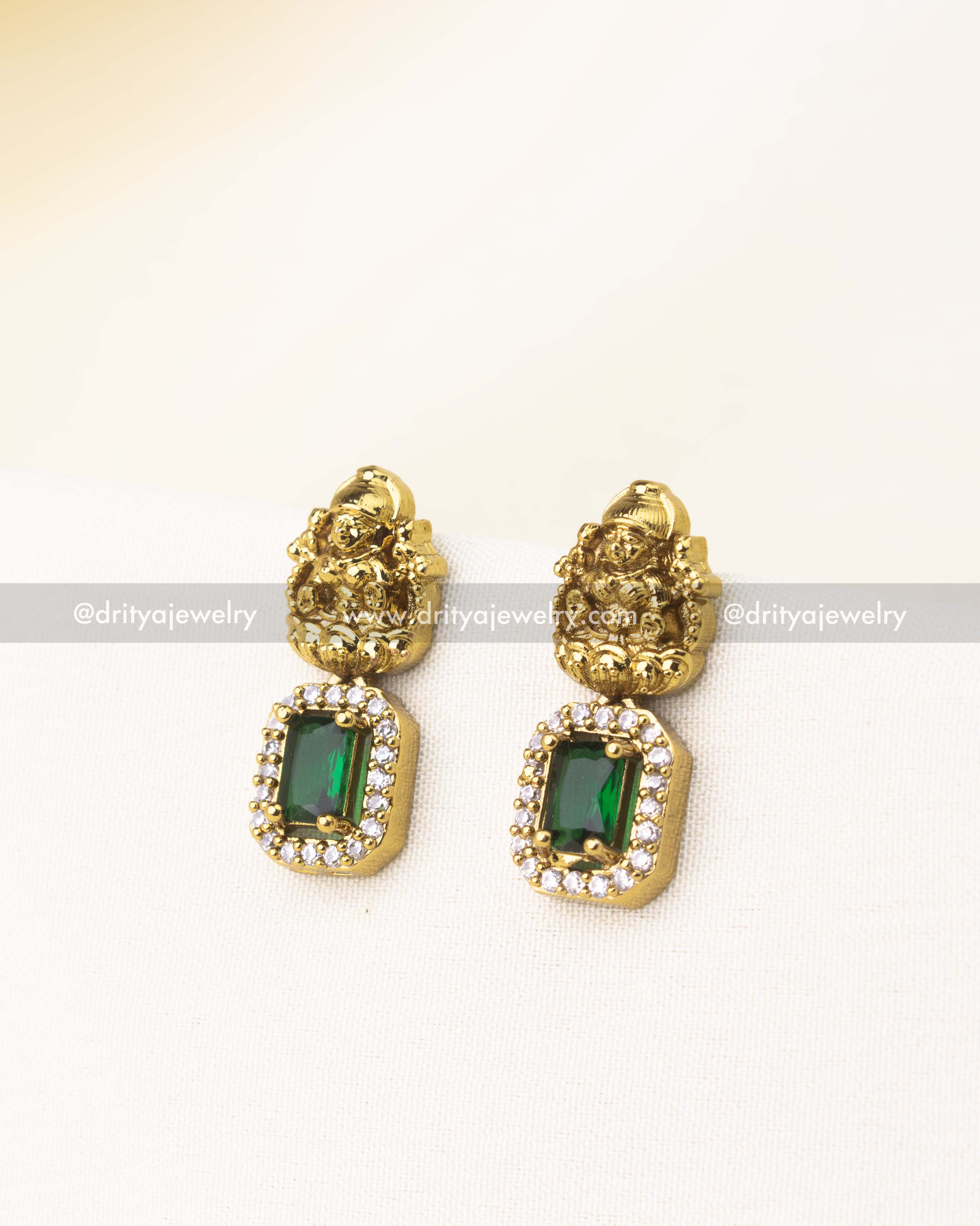 Matching green temple earrings with deity motif and rectangular CZ stones