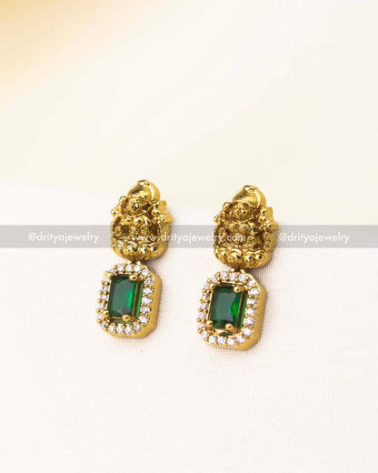 Matching green temple earrings with deity motif and rectangular CZ stones