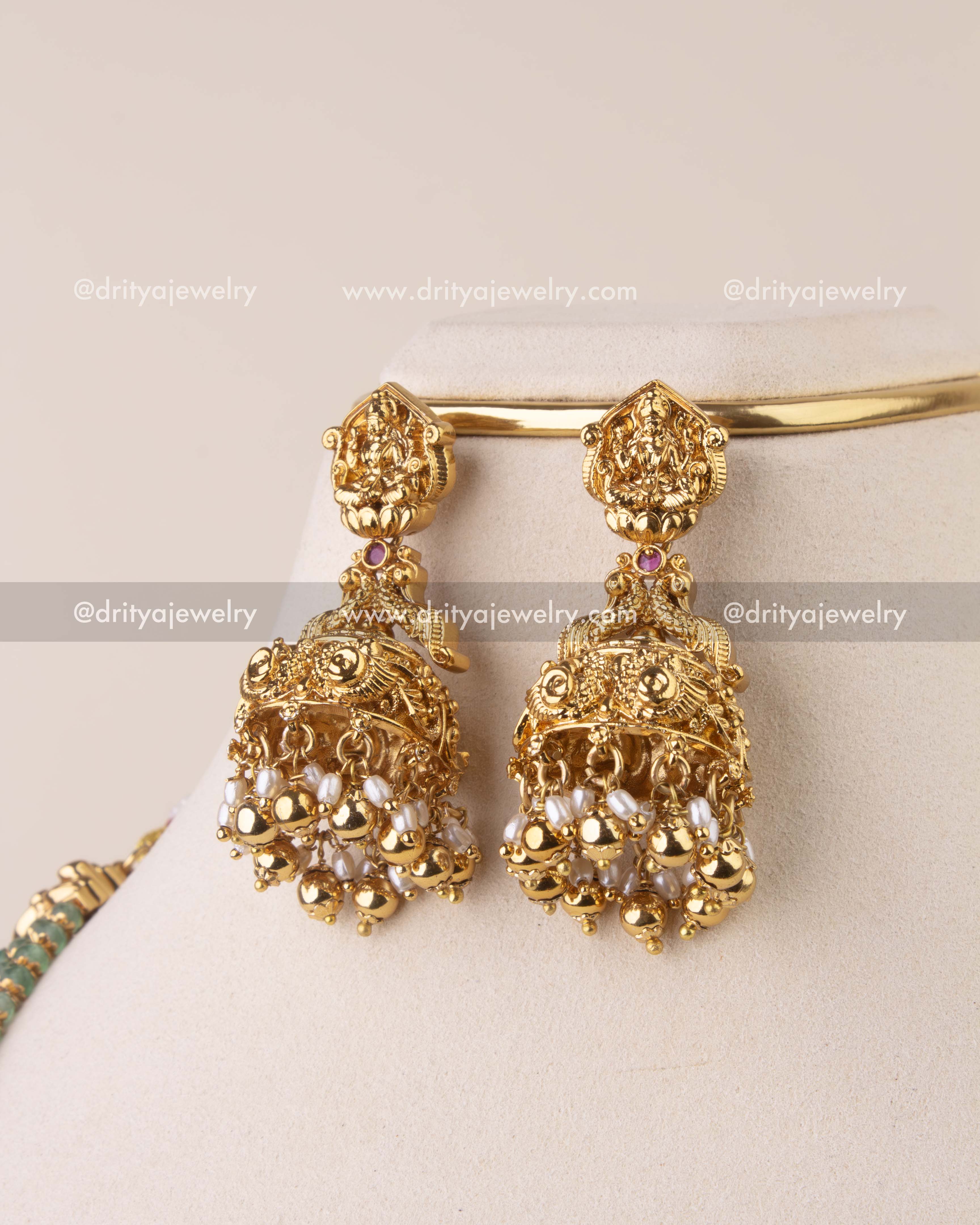 Matching Lakshmi Devi jhumkas with pearls – detailed close-up.