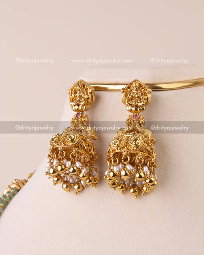 Matching Lakshmi Devi jhumkas with pearls – detailed close-up.