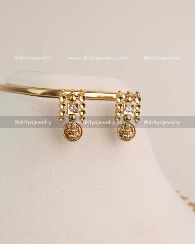 Matching kasulu coin earrings with square CZ stones in premium gold finish.