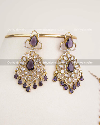 Big-size matching dangler earrings with purple teardrop stones and CZ clusters in Victorian finish.