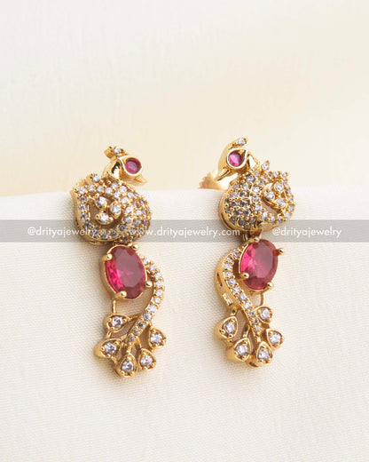 Gold-plated earrings with ruby CZ stones and peacock-shaped tops.
