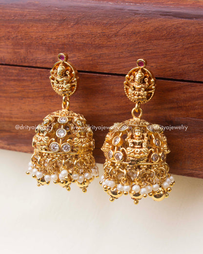 Matching temple jhumka earrings with Lakshmi design, CZ stones, and pearl drops