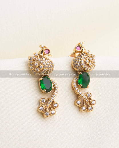 Matching emerald green CZ earrings with peacock top and AD detailing.