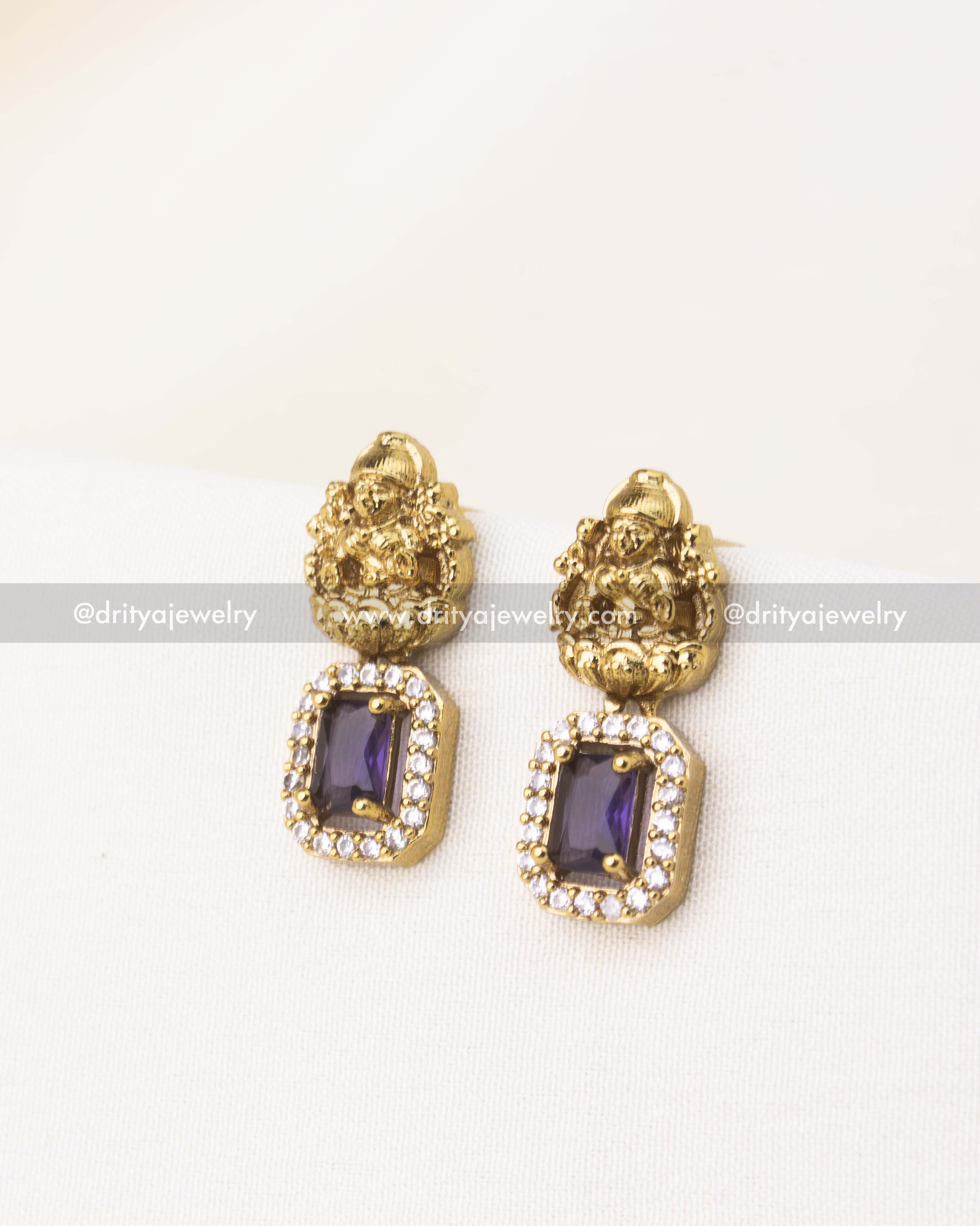 Temple-style earrings with purple CZ stone and deity embossing