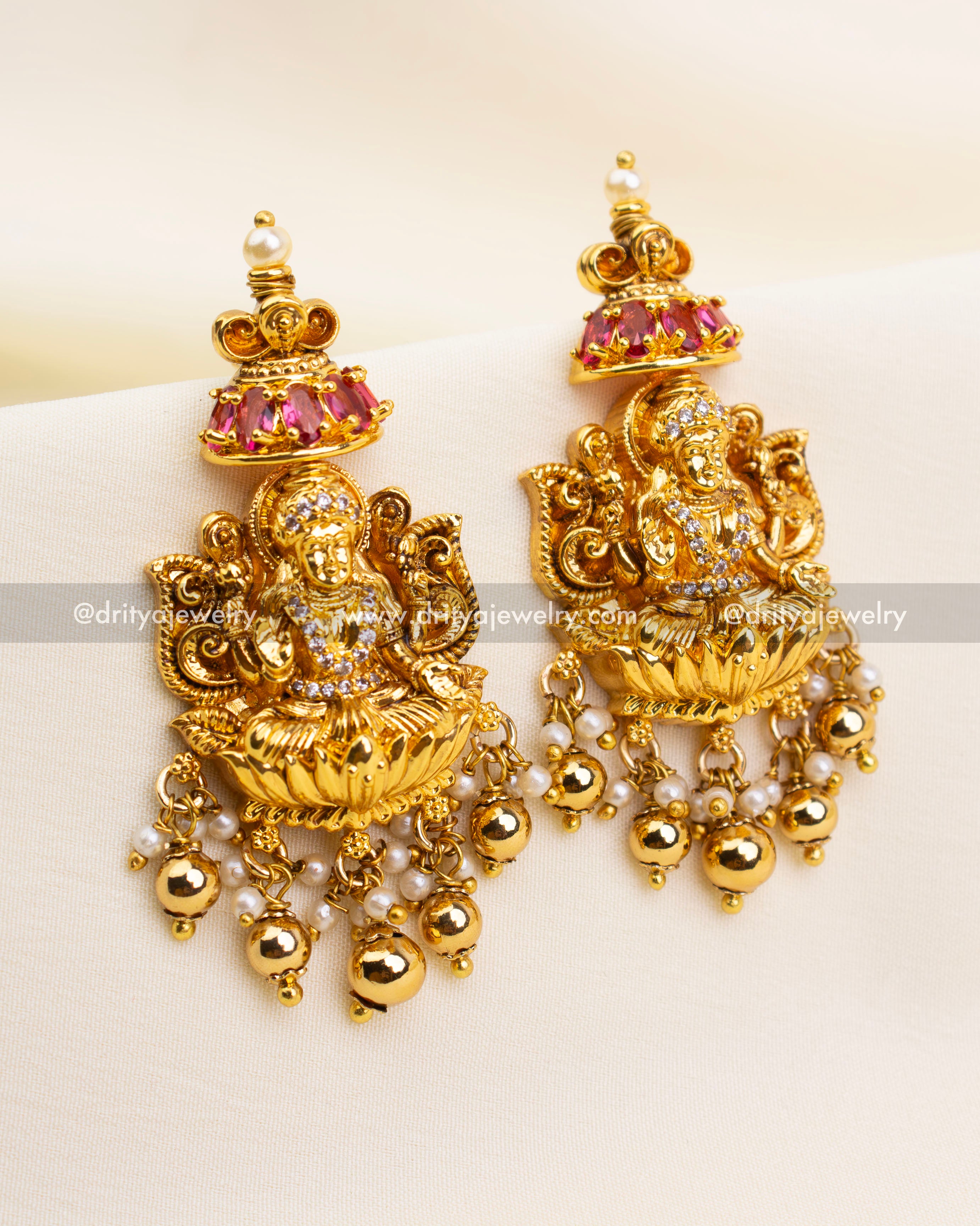 Matching temple-style danglers with ruby center stones and antique finish